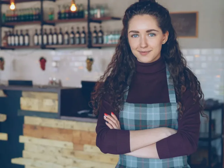 Café owner in an apron behind the counter