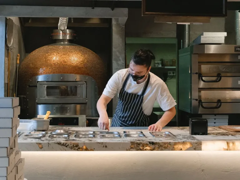 Cook in an apron preparing food in a restaurant kitchen
